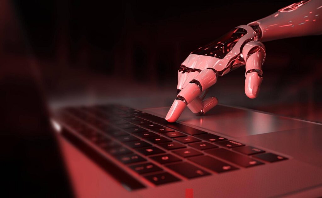 Robotická ruka píše na klávesnici ako symbol automatizácie procesov